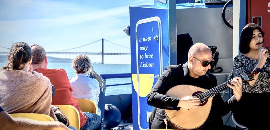 Lisbon: Boat Cruise with Live Fado Performance and a Drink - Alfama from below the hillside