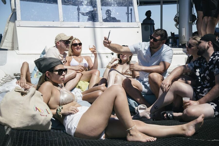 Lisbon: Catamaran Boat Party with Music, Open Bar & Dives - Passing beneath or near the 25 de Abril Bridge
