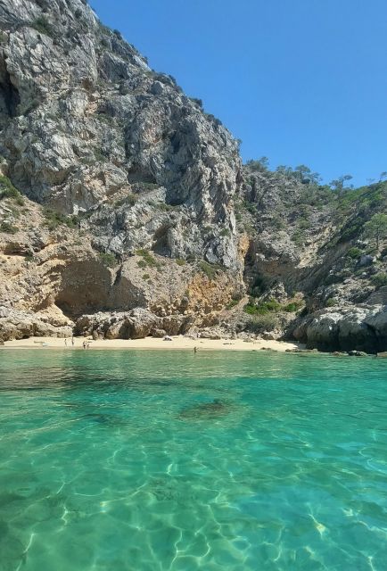 Sesimbra: Secret Bays and Beaches Boat Tour with Snorkeling - A small boat into Sesimbra’s wild coastline